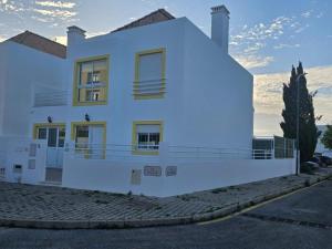 a white house with a balcony in front of it at Casa do Mar - Praia de Manta Rota in Vila Nova de Cacela