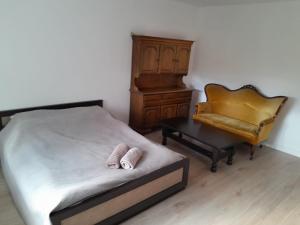 a bedroom with a bed and a chair and a piano at U Mariki 