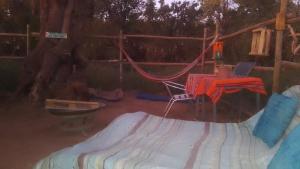 a playground with a hammock and a table and a laptop at Nativo Atacama in El Cerrillo