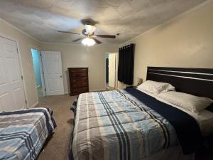 a bedroom with two beds and a ceiling fan at Comfy Getaway in Christiansburg