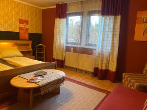 a bedroom with a bed and a table and a window at fun4all-holidayhome in Medebach +124 photos