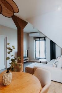 a bedroom with a large bed and a table at HappyApartments - Malbork, Stare Miasto 35 in Malbork