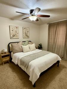 a bedroom with a bed with a ceiling fan at Lovely Provo Oasis in Provo