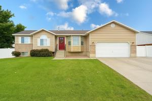 a house with a red door and a garage at Lovely Provo Oasis in Provo