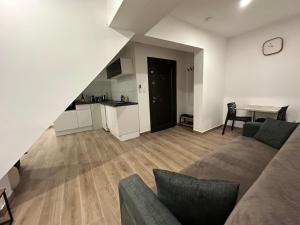 a living room with a couch and a table at Appartement Douceur in Horbourg