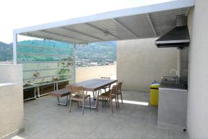 a patio with a table and chairs and a grill at Beautiful cozy very central apartment in San José 