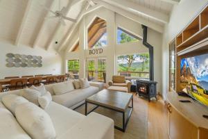 a living room with a white couch and a tv at Banner Elk Valley Overlook in Banner Elk