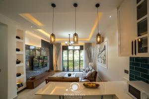 a kitchen and living room with a couch and a table at Lakeside Serenity Stylish 2BR Getaway - Entebbe in Entebbe