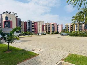 a parking lot in a city with many buildings at Lakeside Serenity Stylish 2BR Getaway - Entebbe in Entebbe