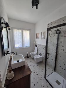a bathroom with a shower and a sink and a toilet at Il Glicine Bianco in Omegna +34 photos