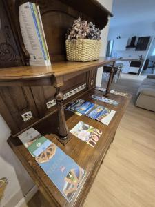 a table with books on it with magazines on it at Il Glicine Bianco in Omegna +36 photos