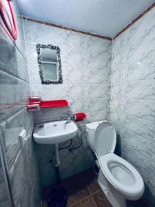a small bathroom with a toilet and a sink at Casa Inas in Chefchaouene