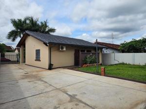 a small house with a driveway in front of it at MH Hostel in Encarnación