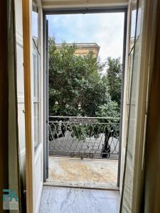 an open door with a view of a balcony at Palermo Central Rooms in Palermo