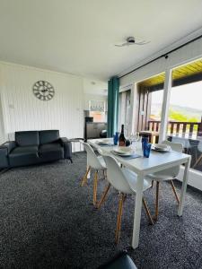 a living room with a table and chairs and a couch at Tigh Na Mara in Dunoon