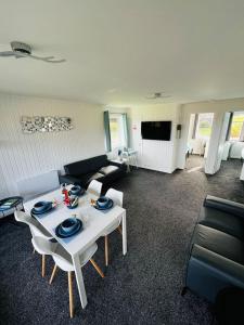 a living room with a white table and a couch at Tigh Na Mara in Dunoon