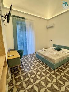 a bedroom with a bed and a desk and a desk at Palermo Central Rooms in Palermo +62 photos