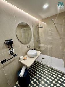 a bathroom with a toilet and a shower with a mirror at Palermo Central Rooms in Palermo +37 photos