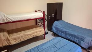 a room with two bunk beds in a room at Departamentos céntricos con parrilla in Punta Alta