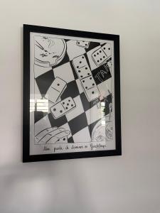 a framed picture of a chessboard on a wall at Ti Belcourt in Baie-Mahault