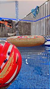 a swimming pool with a red raft in the water at استرحه ام الحمام in Suḩaybah
