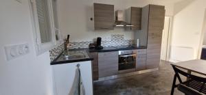 a kitchen with a sink and a stove at Appartement Aubres in Aubres