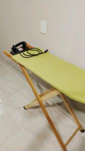 ein grünes Surfbrett auf einem Holzständer in der Unterkunft Cantinho da Vovó in Aparecida