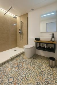 a bathroom with a toilet and a sink and a shower at Coll Natura in Valencia
