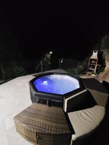 a large pool sitting on a patio at night at Casa Montanha in Campo do Gerês