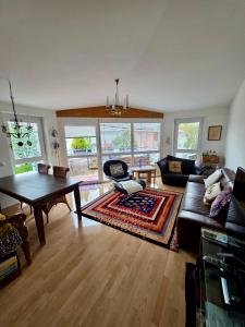 a living room with a couch and a table at SUNNY AND LAKE Wörthersee 140m in Krumpendorf am Wörthersee