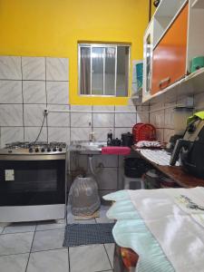a kitchen with a sink and a stove in it at Casa da Lia in Lençóis +2 photos