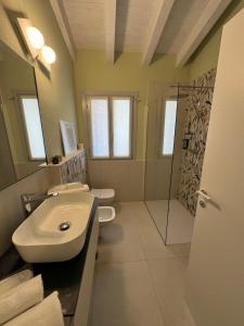 a bathroom with a sink and a shower at A casa di Marzia - 2 in Oleggio