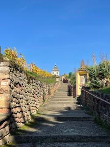 a stone wall and stairs with a building in the background at Studio Alsace in Kirchheim