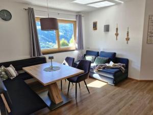 a living room with a couch and a table at Apart Isabella in Brandberg