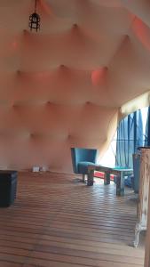 a room with two blue benches in a room at Domo Naranja in Miramar +3 photos