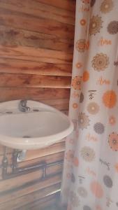 a bathroom with a sink and a shower curtain at Domo Naranja in Miramar