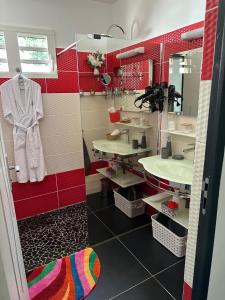 a bathroom with two sinks and a mirror at Les hauts de bellevue in Bouillante +36 photos