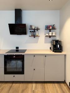 a kitchen with white cabinets and a counter top at Nyrenovert Bergenshus med 2 leiligheter - rolig smau i hjertet av Bergen in Bergen +49 photos
