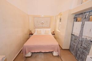 a small bedroom with a bed in a room at Luxury Villas Hariton in Emporio