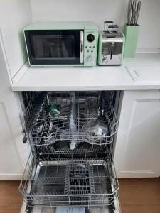 a microwave oven sitting on top of a dishwasher at La Fenice in Mortara +11 photos