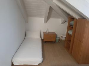 a small bedroom with a bed and a wooden cabinet at La Fenice in Mortara