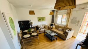 a living room with a couch and a table at Apartamentos Alcazar de Baeza in Baeza