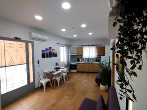 a living room with a table and chairs and a kitchen at Leonidio Downtown Haven in Leonidio
