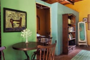 a dining room with a table and some chairs at Casa Poesía Sayulita in Sayulita