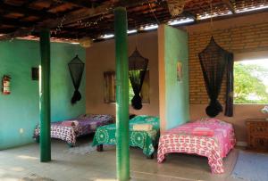 two beds in a room with green walls at Casa Poesía Sayulita in Sayulita