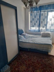 a small bedroom with a bed and a window at Dayana in Varna City