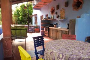 a kitchen with a table and chairs in a room at Casa Poesía Sayulita in Sayulita