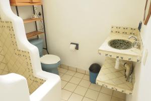 a small bathroom with a sink and a toilet at Casa Poesía Sayulita in Sayulita +26 photos