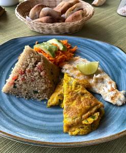 a blue plate with three pieces of food on a table at Titicaca Lodge Amantani in Amantani +25 photos