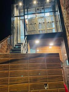 a cat sitting on top of some wooden stairs at My Perfect Stay in Ayodhya